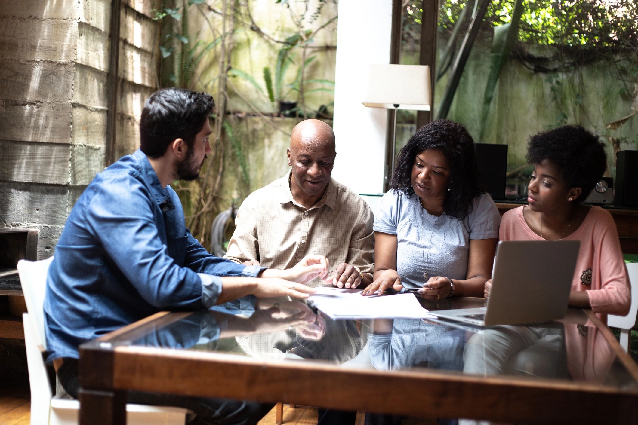 Consultant showing information to a family at home
