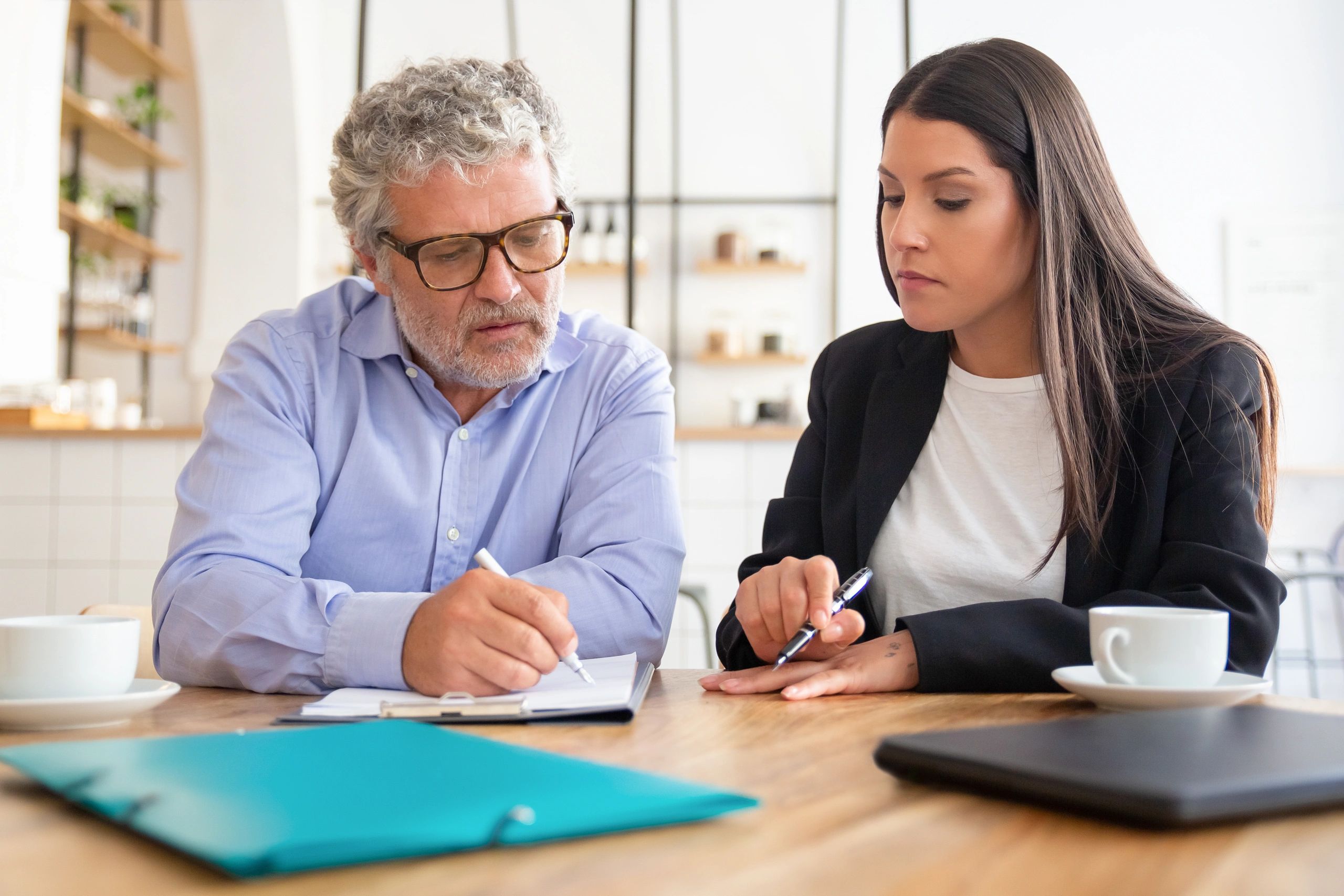 Mature client reviewing an agreement with an advisor