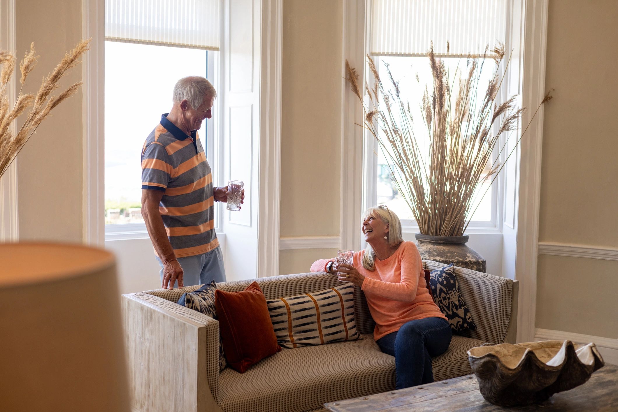 Mature couple relaxing together in a bright lounge